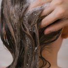 Female washing her hair. closeup, selective focus